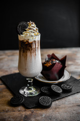 coffee drink with whipped cream and round chocolate chip cookies and brownie