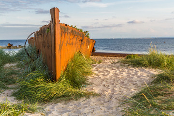 An old rusty and damaged  batteship wreck on the  beach. Hel,  Poland