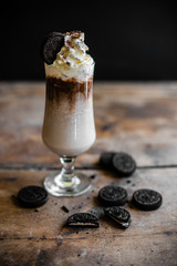 coffee drink with whipped cream and round chocolate chip cookies and brownie