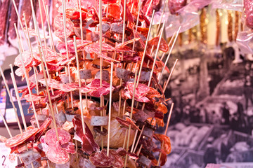 Decorative meat snacks on sticks at a spanish market