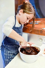 beautiful girl preparing a chocolate cake