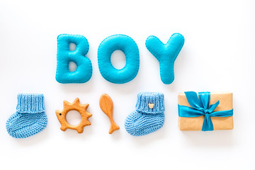 Boy's birthday concept. Set in blue colors with gift box on white backgound top view