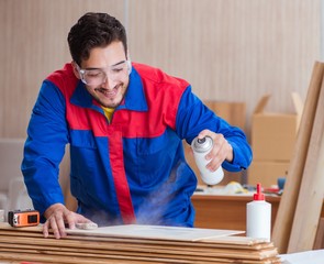 Yooung repairman carpenter working with paint painting