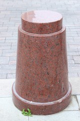 Naklejka premium A small beautiful pillar of red granite. Moscow. Russia.