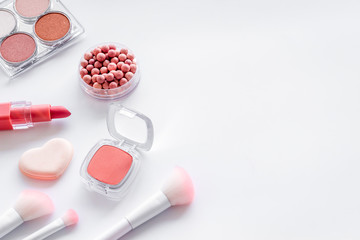 Decorative cosmetics frame with rounge, powder and tools on white background copy space