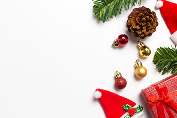 Top view Christmas composition. Gifts, Pine cones and Christmas Santa Claus Hats red decorations on white background. Happy new year concept.