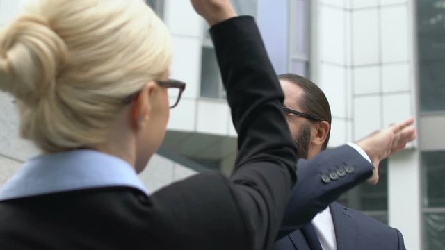 Handsome middle ages businessman giving high-five to lady, successful enterprise