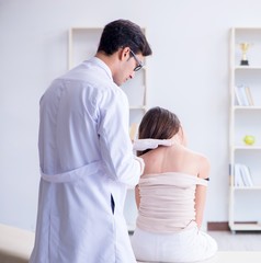 Doctor examining the skin of female patient