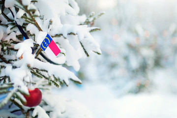 North Carolina flag. Christmas tree branch with a flag of North Carolina state. Xmas holidays...