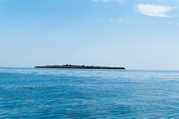Fototapeta premium Sea view with an island in the distance.