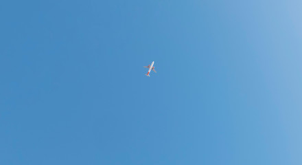Plane at cruising altitude against blue sky