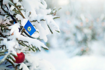 Vermont flag. Christmas tree branch with a flag of  Vermont state. Xmas holidays greetings card....