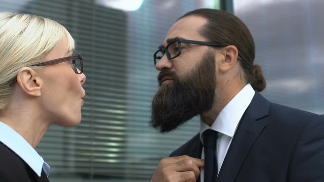 Male and lady in suits arguing about company development, having disagreement