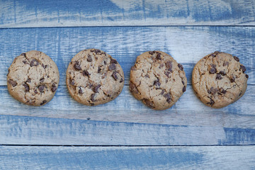 Four chocolate cookies on a wooden board