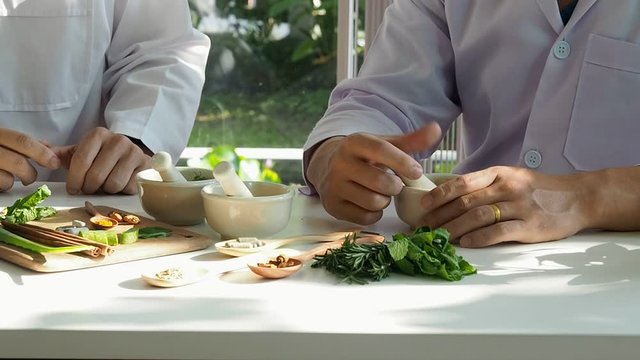 The scientist or doctor make herbal medicine from herb in the laboratory on the table. Herb medicine with herbal the organic natural in the laboratory.