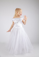 Little beautiful child girl wearing wedding dress dress standing over isolated gray background showing and pointing up with fingers number five while smiling confident and happy.