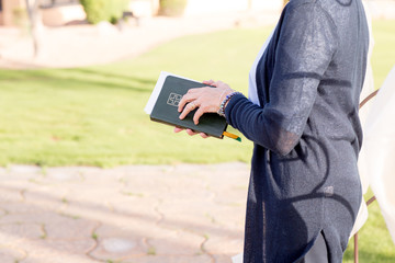 female minister preacher holding bible at wedding ceremony