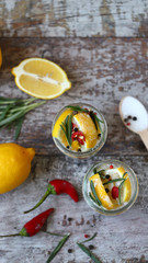 Fermented lemons in jars. Salty pickled lemon. Probiotics and fermented foods. Selective focus. Macro.
