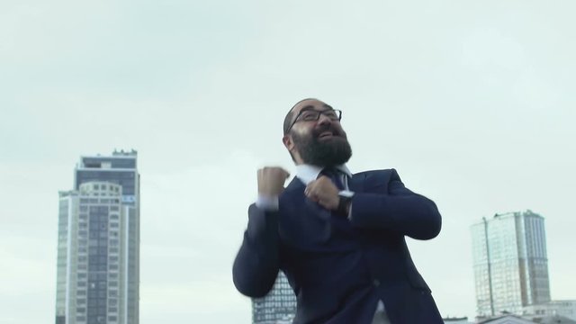 Motivated man in formalwear making yes-gesture, celebrating successful business