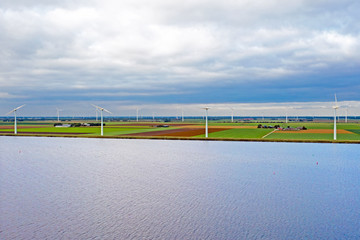 Aerial from windmills at the waterfront in the countryside from the Netherlands