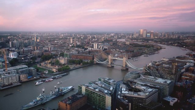 time lapse London skyline with Tower bridge and Canary Wharf in sunset time, UK