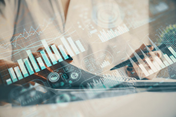 Financial chart drawn over hands taking notes background. Concept of research. Multi exposure