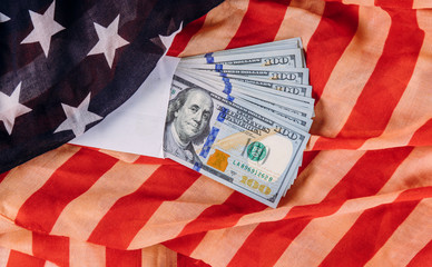 US 100 dollars wrapped in the US flag