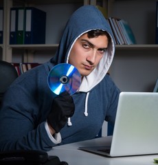 The young hacker hacking into computer at night