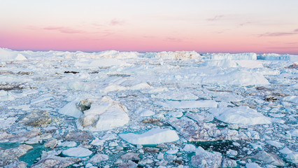 Global warming - Greenland Iceberg landscape of Ilulissat icefjord with giant icebergs. Icebergs from melting glacier. Arctic nature heavily affected by climate change © Maridav