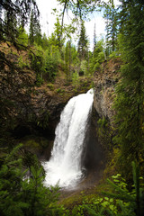 view of moul falls in wells gray provincial park, unique walk behind waterfall in canada after long hike