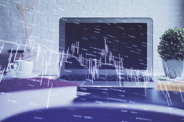 Forex market graph hologram and personal computer on background. Multi exposure. Concept of investment.