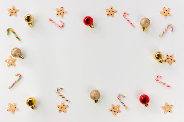 Christmas background concept. Top view of Christmas decoration, colorful star, colorful balls and candy cane on white background with copy space for text.