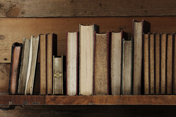old books on wooden shelf.