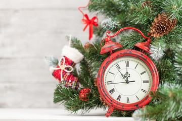 Christmas card with decorated fir tree and clock
