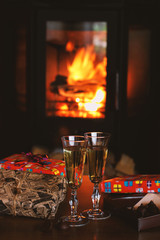 Champagne glasses on the background of the fireplace
