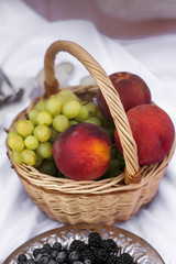 Flat lay Summer Picnic on the beach at sunset in the white plaid, food and drink conception. Top view