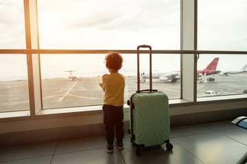 Boy at the airport looks at planes