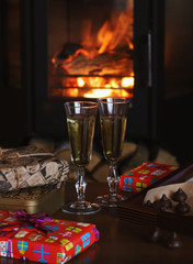 Champagne glasses on the background of the fireplace