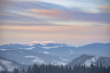 Beautiful Carpathian Mountains in Fog. Winter Sunset Landscape.