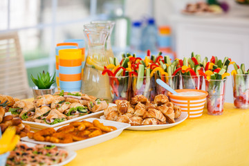 Fototapeta premium buffet for celebration birthday food on plates, home made sandwiches and decorations