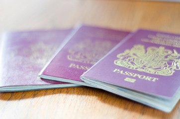 3 passports on wooden surface