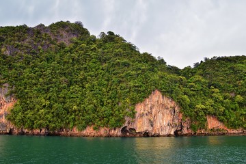 Island, Ocean views near Phuket Thailand with Blues, Turquoise and Greens oceans, mountains, boats, caves, trees resort island of phuket Thailand. Including Phi Phi, Ko Rang Yai, Ko Li Pe and other is