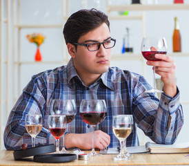 Professional sommelier tasting red wine