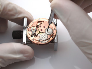 watchmaker repairing old watch movemenet