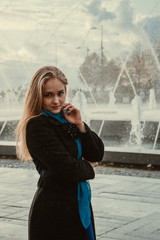 girl on the background of the fountain in autumn