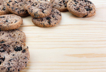 Tasty cookies with chocolate chips placed on a wooden background . Selective focus shot.