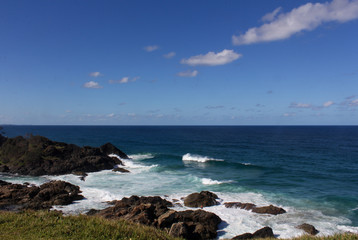 Fototapeta na wymiar Pacific Ocean Meets Australian East Coast with Shades of Blue and Big Waves Hitting the Rocks