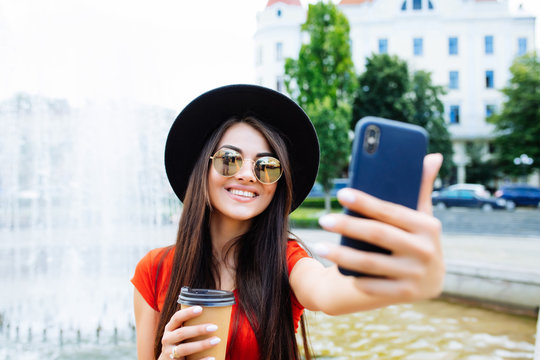 Pretty Young Woman Taking A Selfie With Cup Of Coffee To Go In The Street