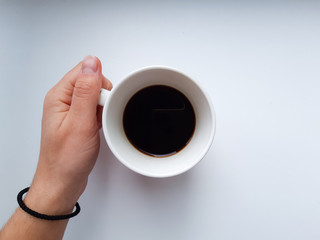 hand holding cup of coffee