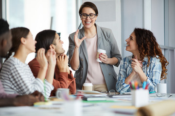 Portrait of emotional businesswoman presenting ideas to creative team during meeting in office, copy space